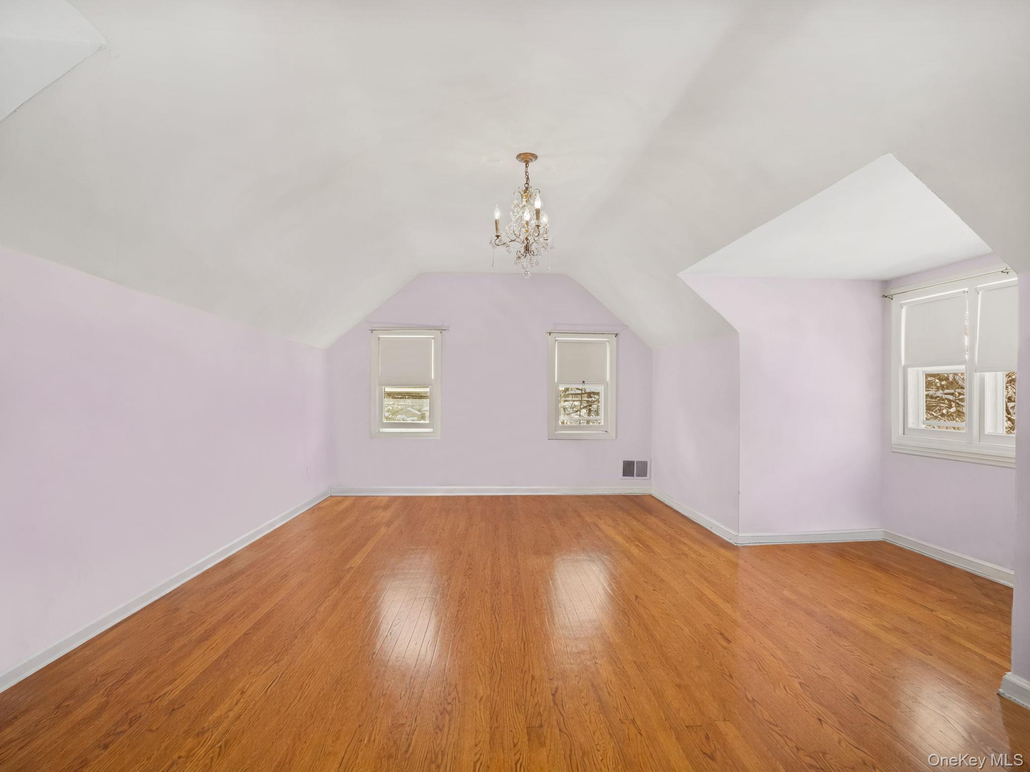 1 Village Lane Bronxville, NY 10708 - Photo 13 of 16 an empty room with wooden floor ceiling fan and windows
