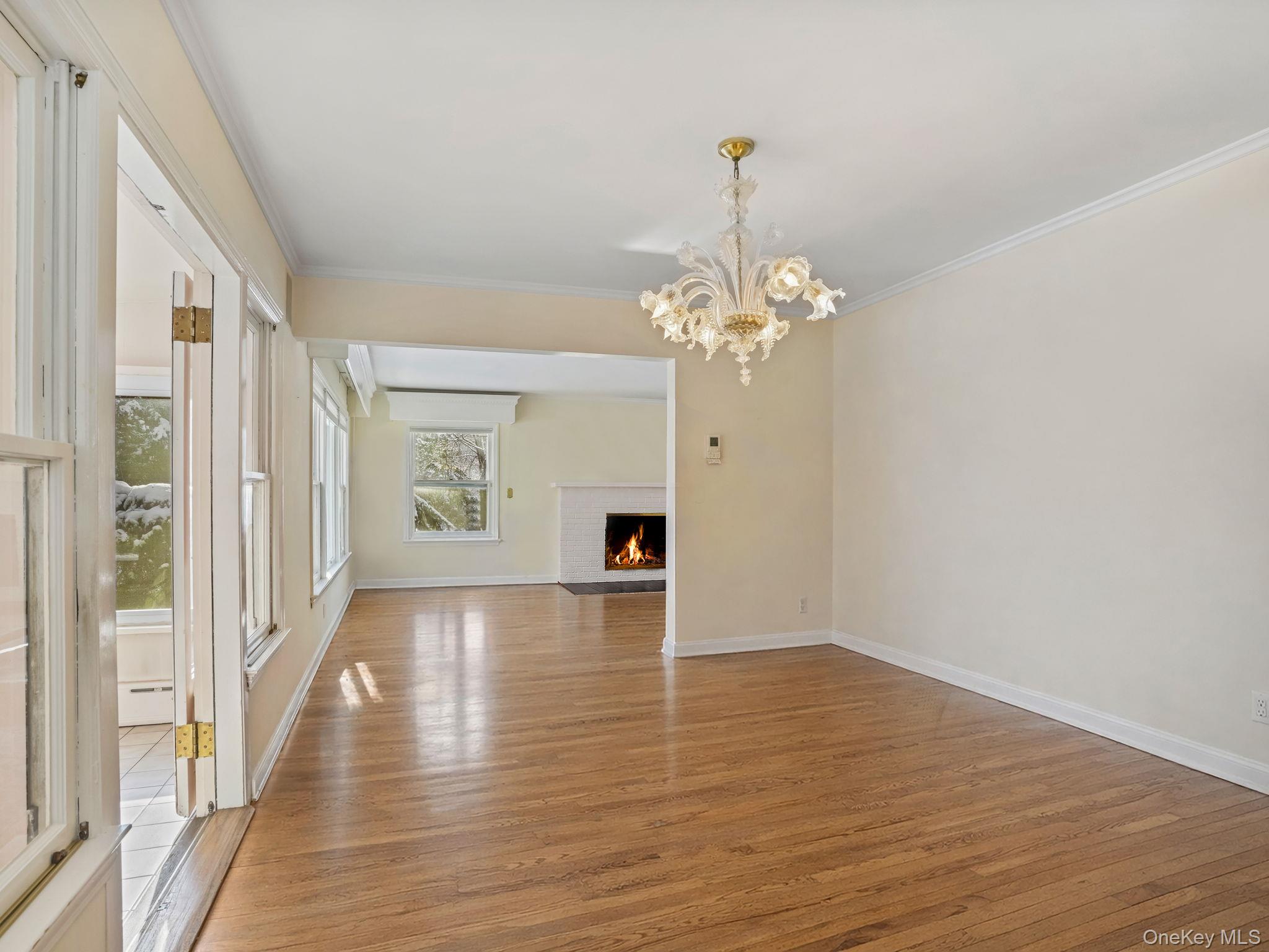 1 Village Lane Bronxville, NY 10708 - Photo 6 of 16 a view of a room with wooden floor and chandelier