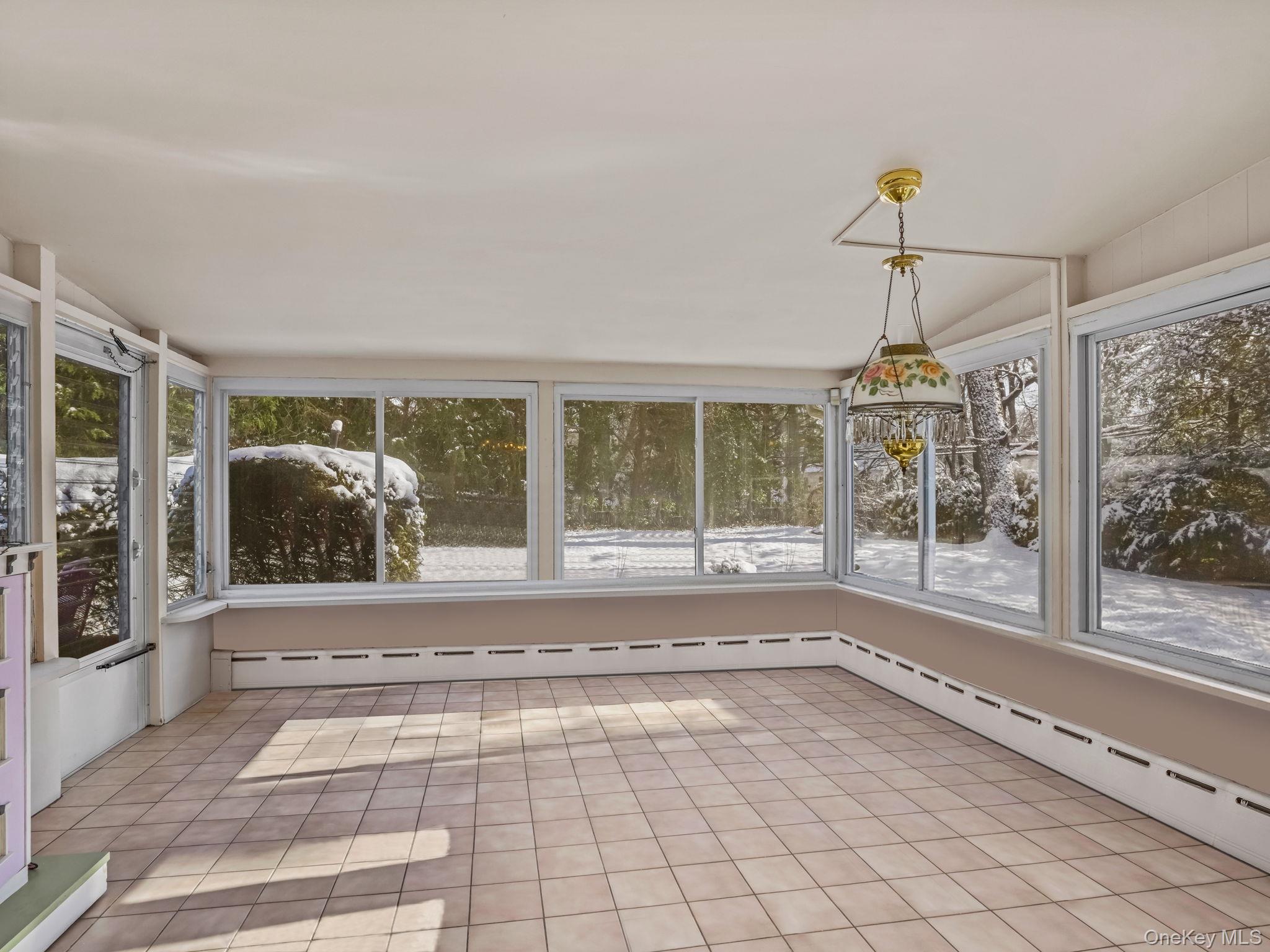 1 Village Lane Bronxville, NY 10708 - Photo 8 of 16 a view of empty room with windows and chandelier