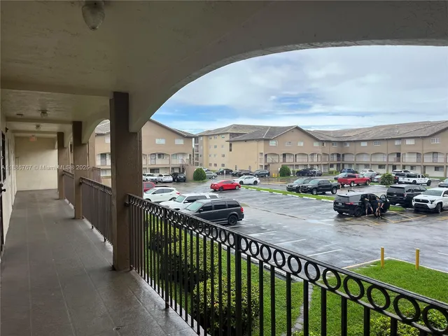 a view of a chairs and cars in front of the house