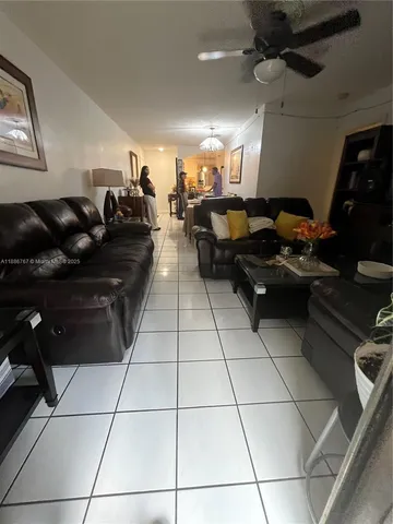 a living room with lots of appliances and cabinets