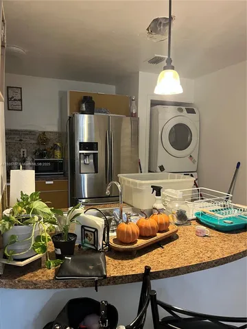 a kitchen with sink refrigerator and stove