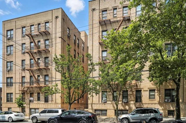 a couple of cars parked in front of a building