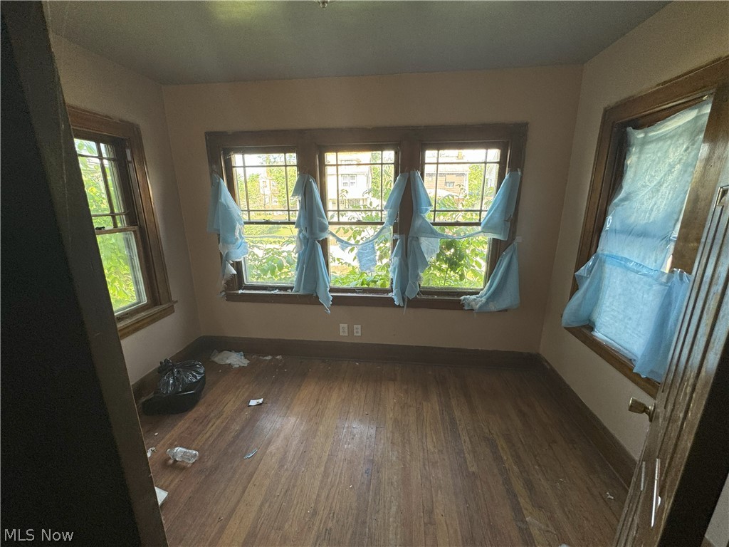 971 Helmsdale Road Cleveland Heights, OH 44112 - Photo 3 of 19 Unfurnished room featuring dark hardwood / wood-style floors and a wealth of natural light