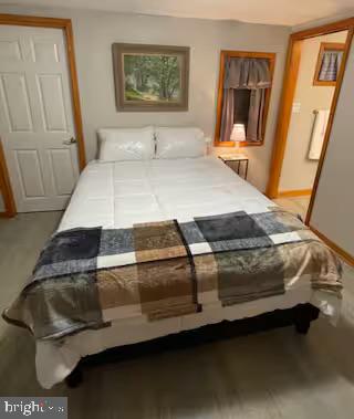 379 River Road, Unit A Elkton, MD 21921 - Photo 9 of 20 a bedroom with a bed and wooden floor