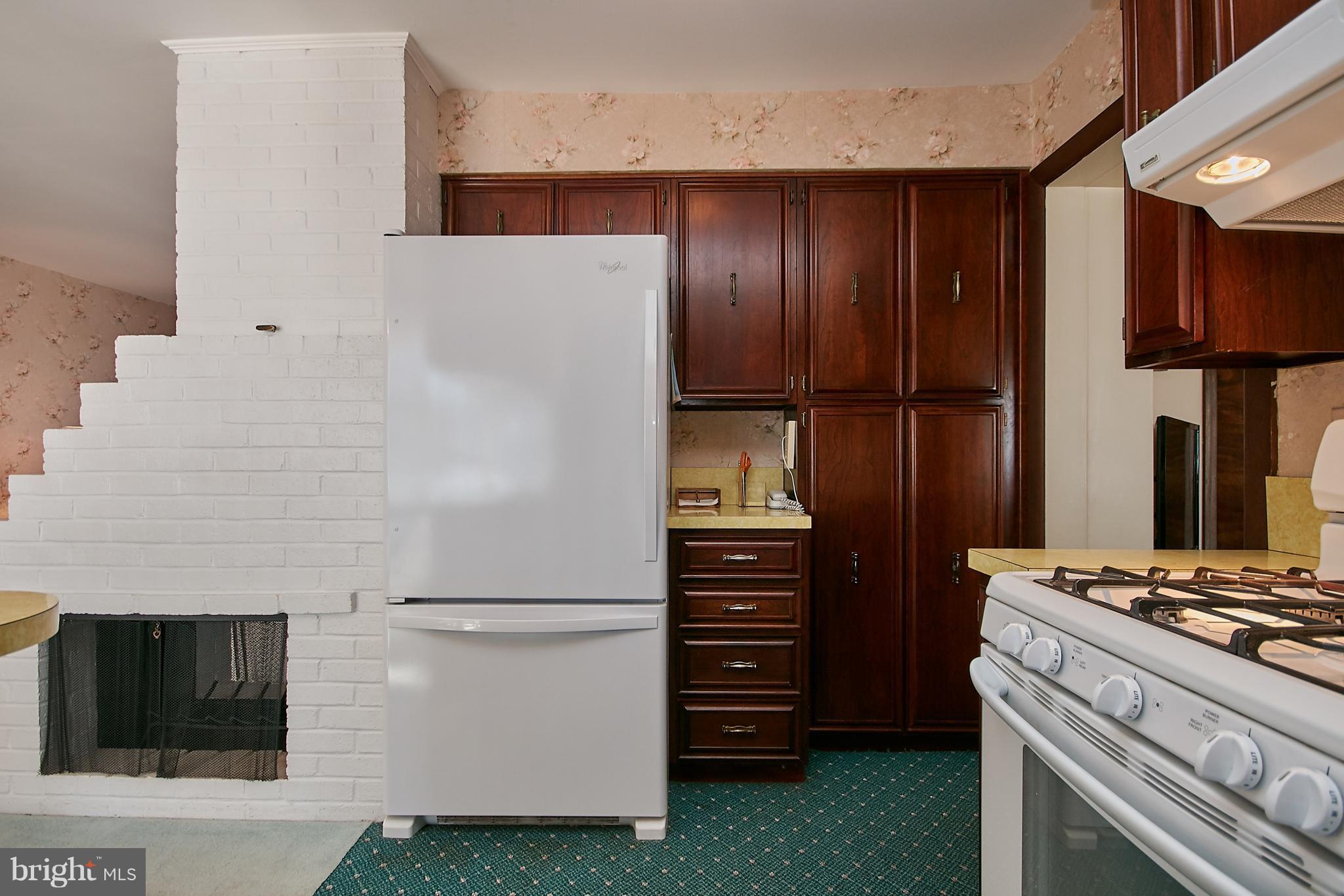 7311 Floyd Avenue Springfield, VA 22150 - Photo 12 of 33 Kitchen and 2 Sided Fireplace in Dining Room