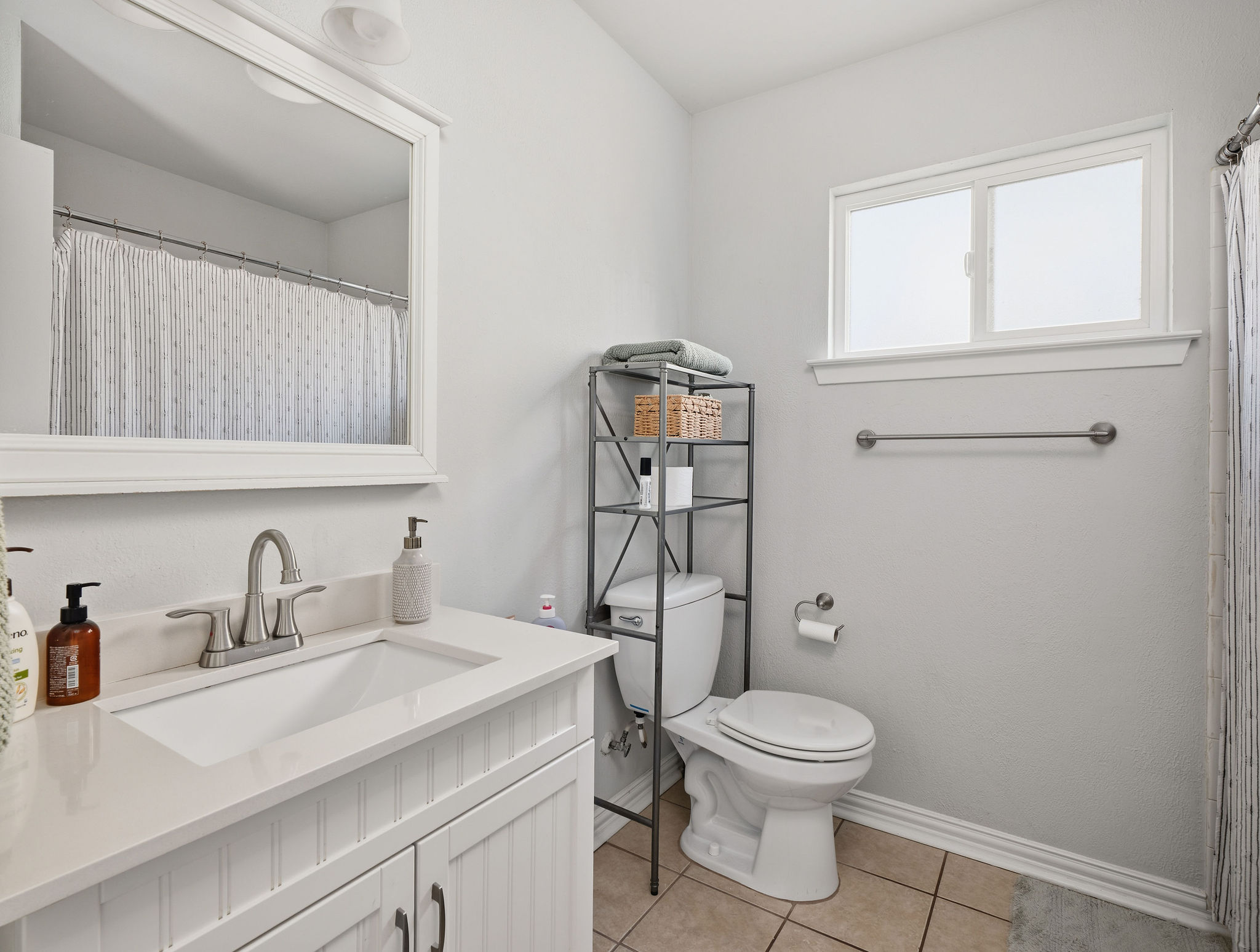 2008 Lear Lane Austin, TX 78745 - Photo 27 of 32 a bathroom with a toilet a sink and mirror
