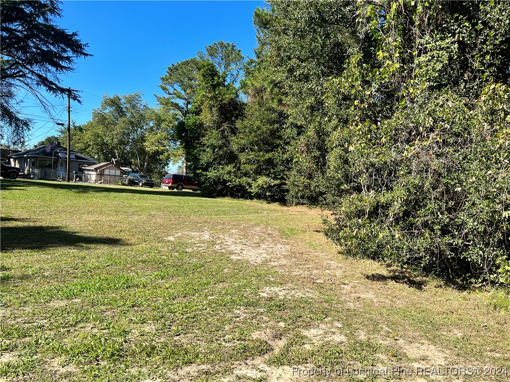 122 North 1st Street Spring Lake, NC 28390 - Photo 2 of 4 a view of a swimming pool with an outdoor space and seating area