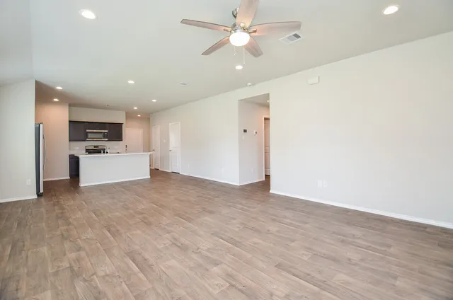 a view of a kitchen with a sink and a refrigerator