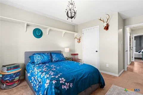 a bedroom with a bed and a wooden floor