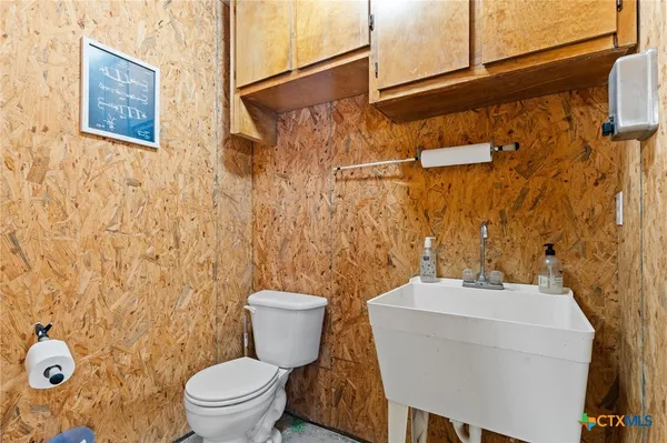 a white toilet sitting next to a bathroom sink