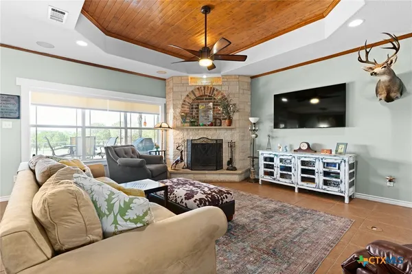 a living room with furniture a flat screen tv and a fireplace