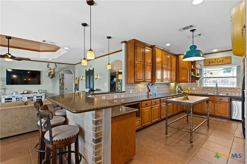 a kitchen with a table chairs stove and cabinets