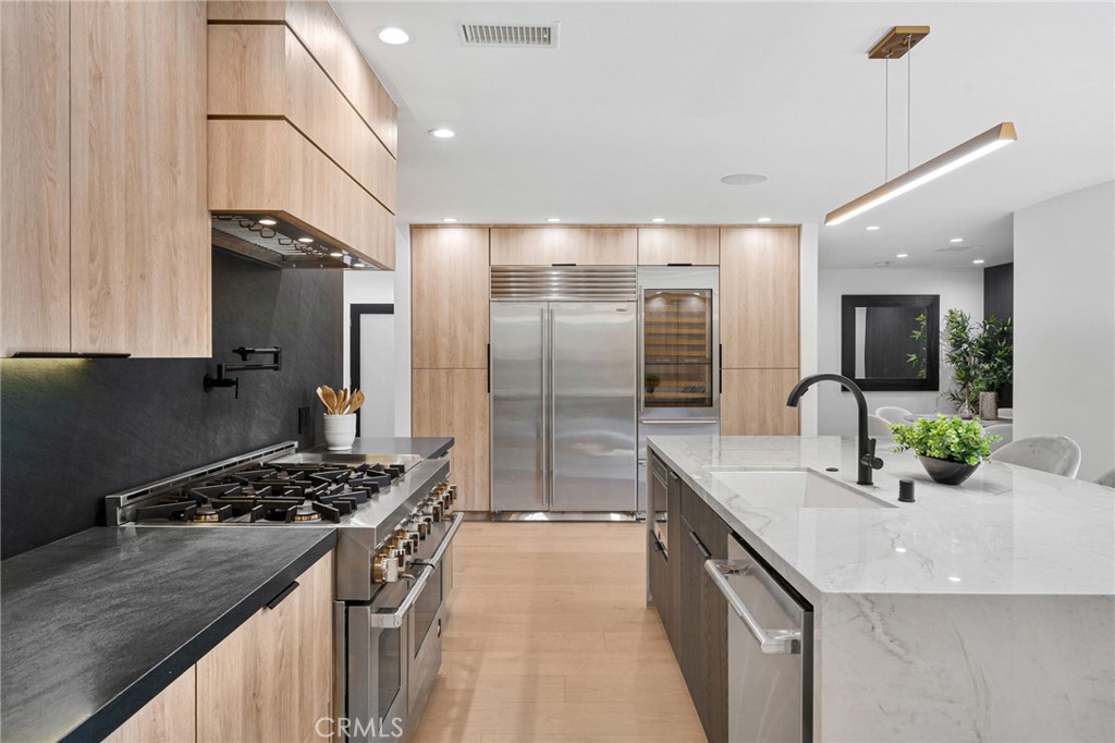 4731 Caritina Drive Tarzana, CA 91356 - Photo 16 of 42 a kitchen with stainless steel appliances granite countertop a sink stove and refrigerator