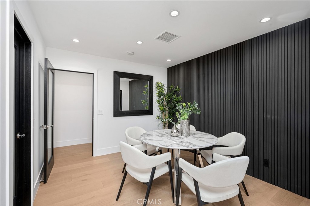4731 Caritina Drive Tarzana, CA 91356 - Photo 18 of 42 a dining room with furniture and wooden floor