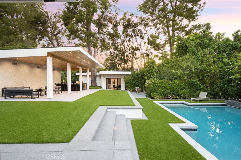 4731 Caritina Drive Tarzana, CA 91356 - Photo 19 of 42 a view of house with swimming pool and a yard