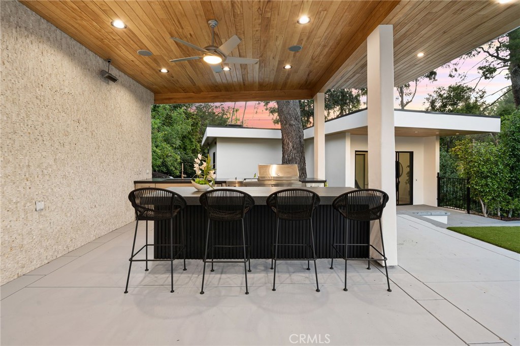 4731 Caritina Drive Tarzana, CA 91356 - Photo 24 of 42 a front view of a house with table and chairs