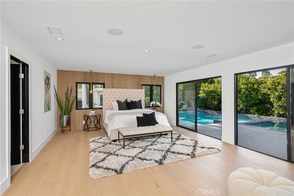 4731 Caritina Drive Tarzana, CA 91356 - Photo 29 of 42 a living room with furniture large windows and wooden floor