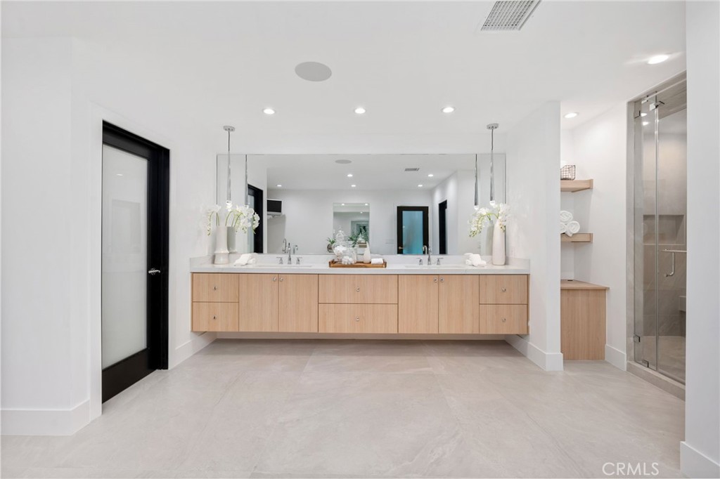 4731 Caritina Drive Tarzana, CA 91356 - Photo 32 of 42 a large white bathroom with a large tub sink vanity and mirror