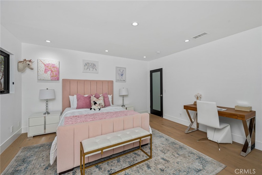 4731 Caritina Drive Tarzana, CA 91356 - Photo 38 of 42 a bedroom with a bed and a chair