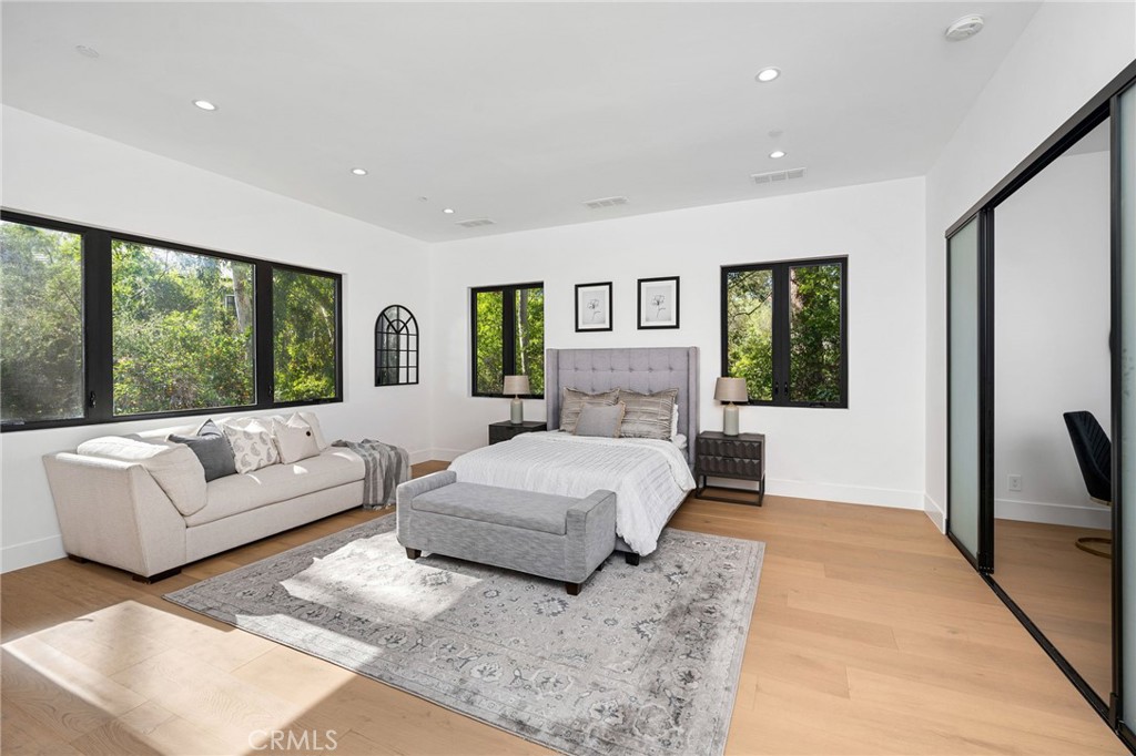 4731 Caritina Drive Tarzana, CA 91356 - Photo 40 of 42 a bedroom with a large bed couch and a large window