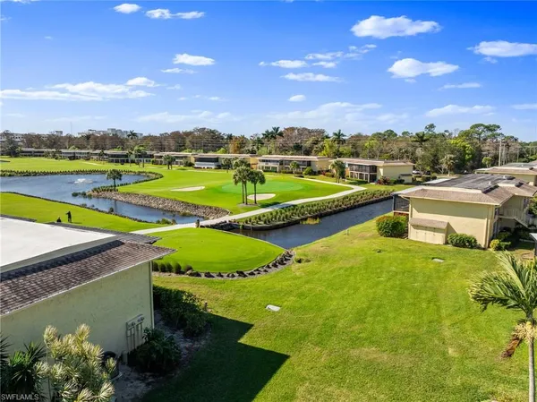 a view of a house with a swimming pool and a yard