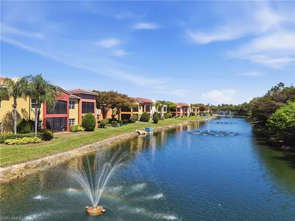 a view of a lake with a house in the background