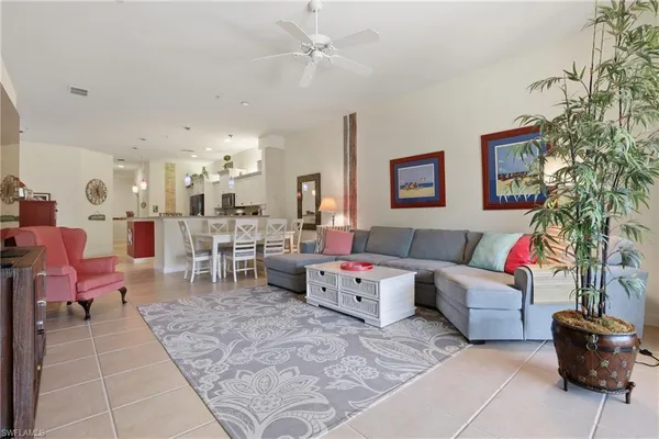 a living room with furniture and a potted plant