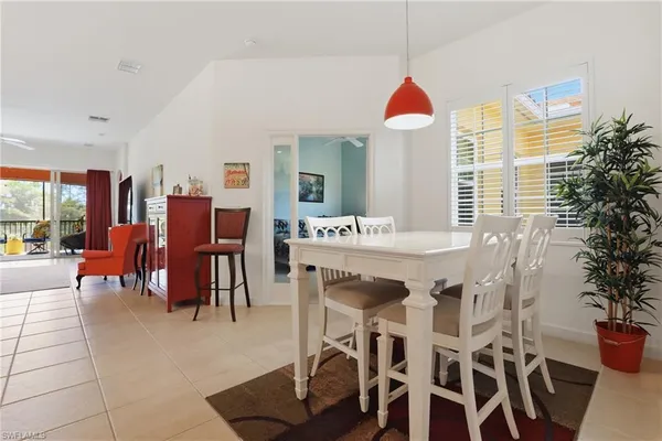 a dining hall with furniture and a floor to ceiling window