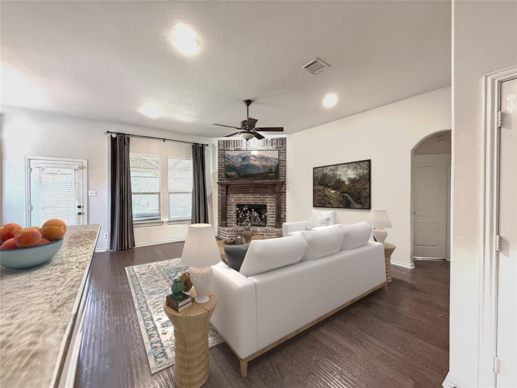 1301 Meadow Ranch Road McKinney, TX 75071 - Photo 15 of 40 Living area with arched walkways, ceiling fan, dark wood-style floors, a brick fireplace, and recessed lighting