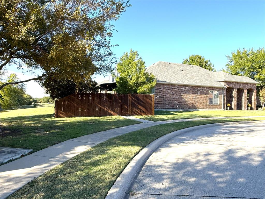 1301 Meadow Ranch Road McKinney, TX 75071 - Photo 2 of 40 View of side of home featuring a shingled roof and brick siding