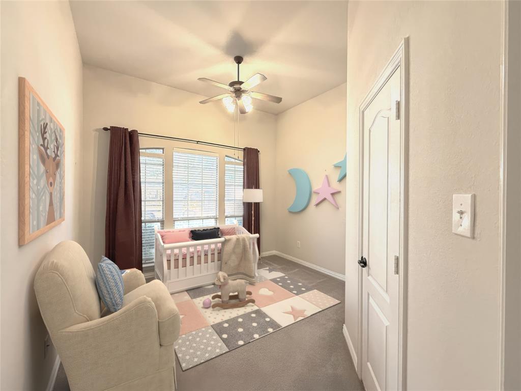 1301 Meadow Ranch Road McKinney, TX 75071 - Photo 23 of 40 Bedroom with a crib, a ceiling fan, and carpet