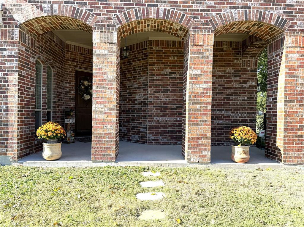 1301 Meadow Ranch Road McKinney, TX 75071 - Photo 5 of 40 Entrance to property with brick siding and a lawn