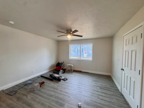 a view of room with a window and wooden floor