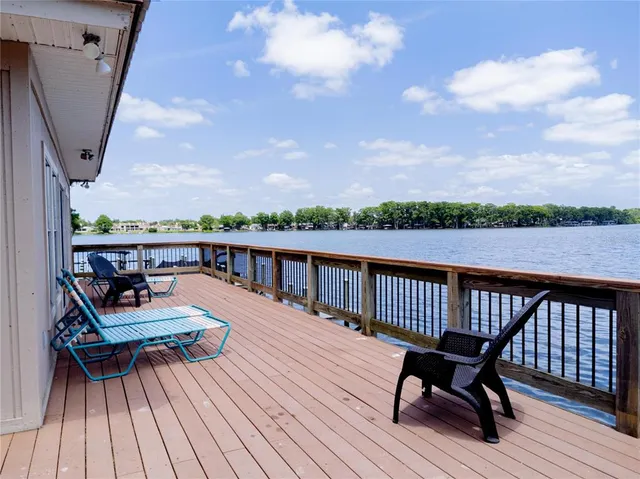 a view of balcony with wooden floor and seating space