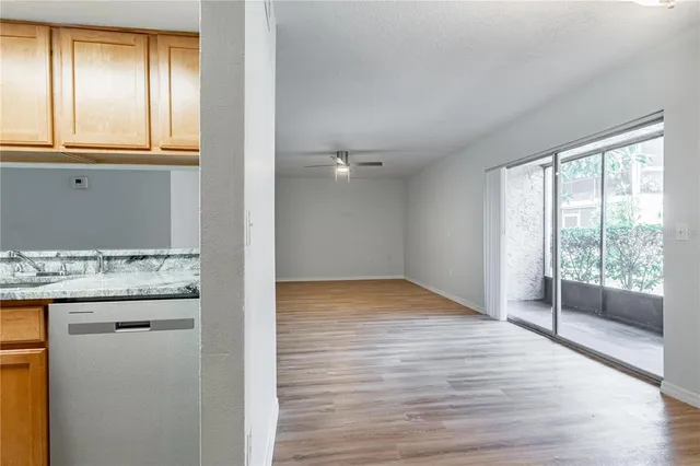 a view of kitchen with granite countertop cabinets and wooden floor