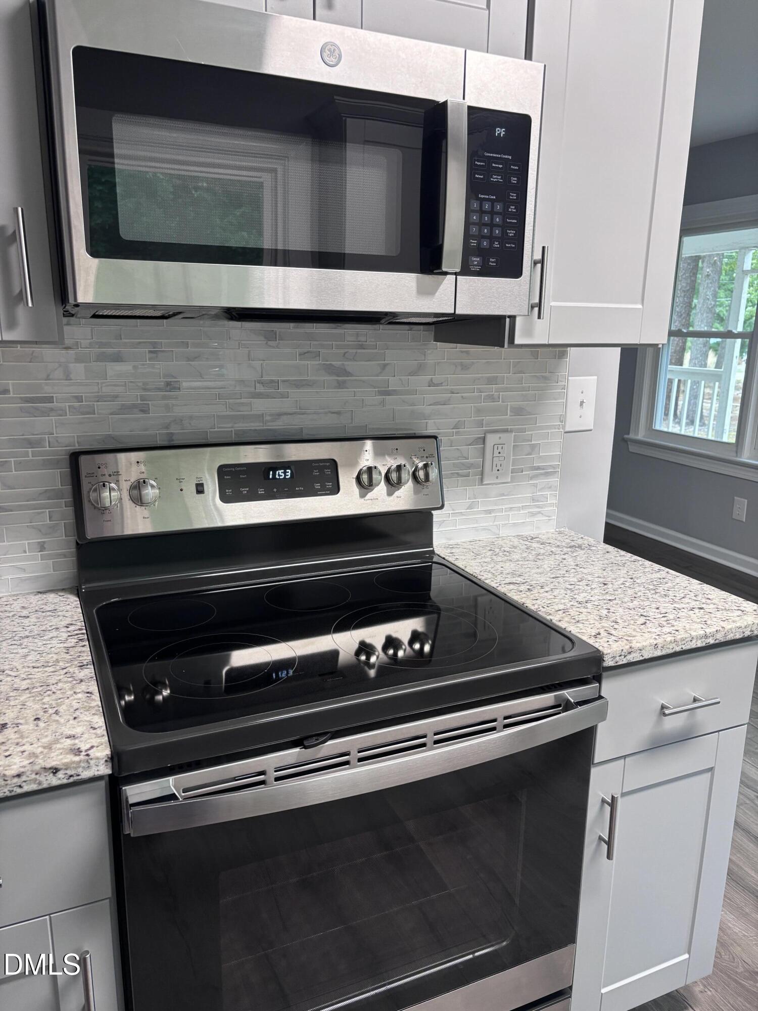 504 St Andrews Church Road Sanford, NC 27332 - Photo 3 of 22 a kitchen with granite countertop cabinets stove and microwave