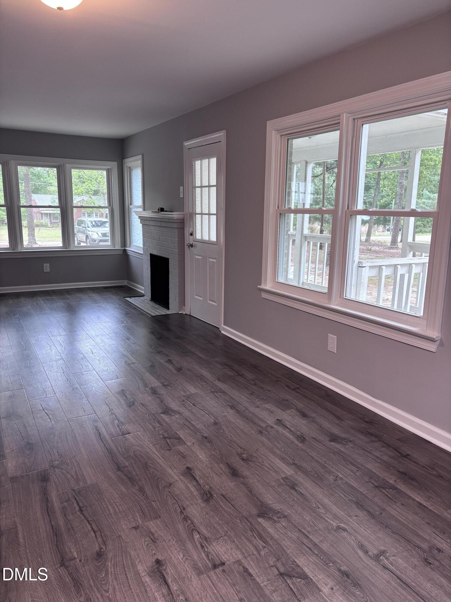 504 St Andrews Church Road Sanford, NC 27332 - Photo 6 of 22 a view of empty room with wooden floor and fireplace