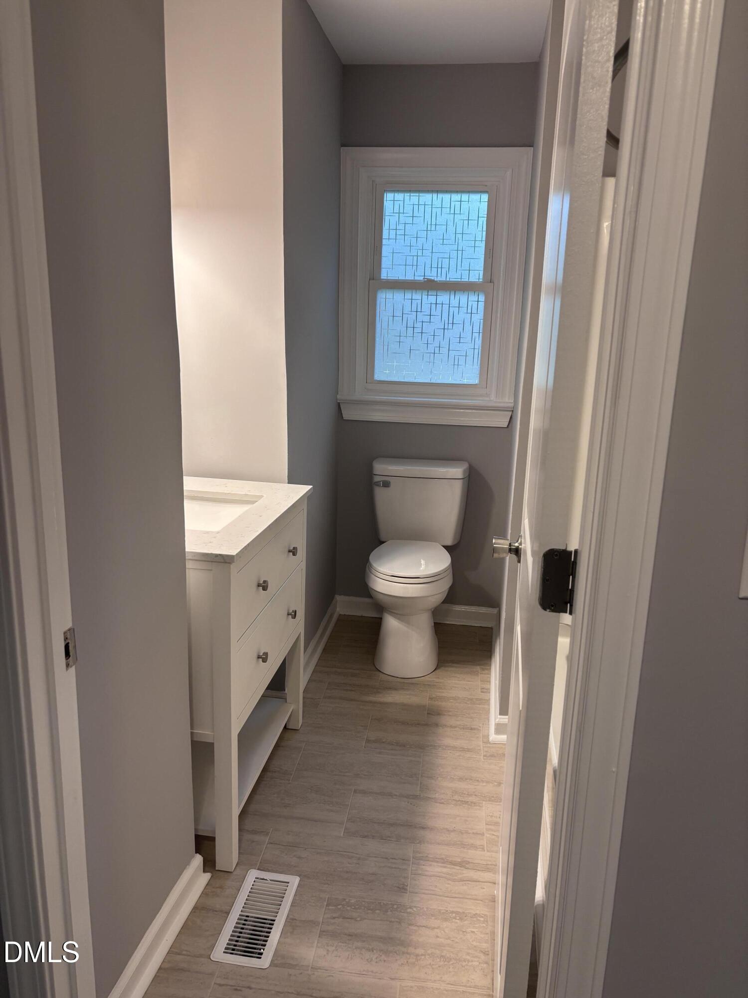 504 St Andrews Church Road Sanford, NC 27332 - Photo 7 of 22 a bathroom with a toilet a sink and a window