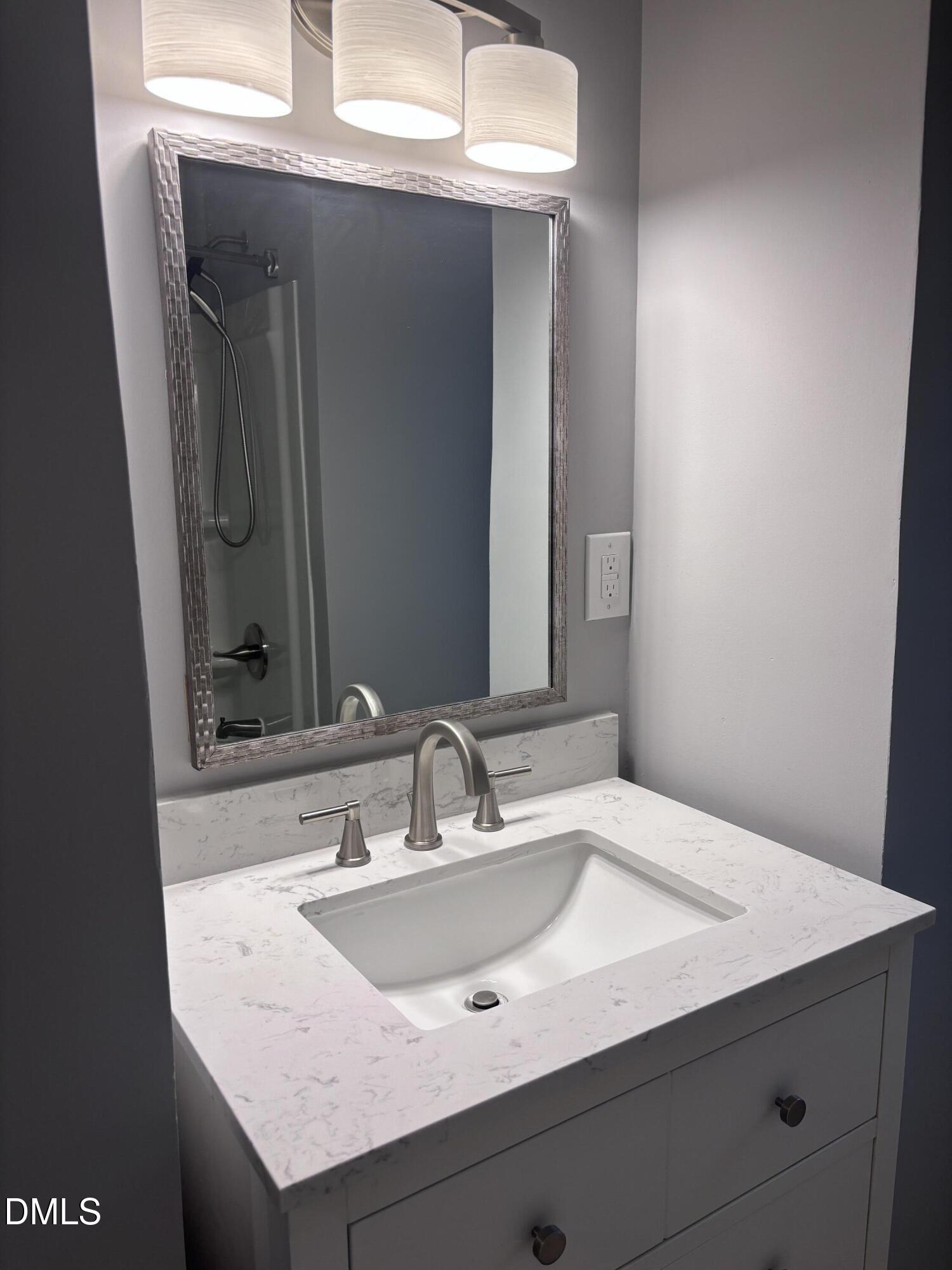 504 St Andrews Church Road Sanford, NC 27332 - Photo 8 of 22 a bathroom with a sink and a mirror