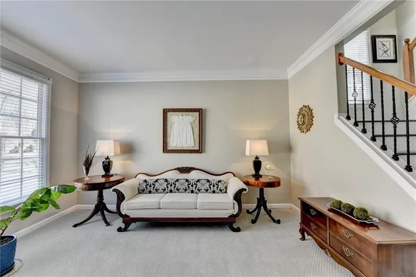 a dining room with furniture a chandelier and wooden floor
