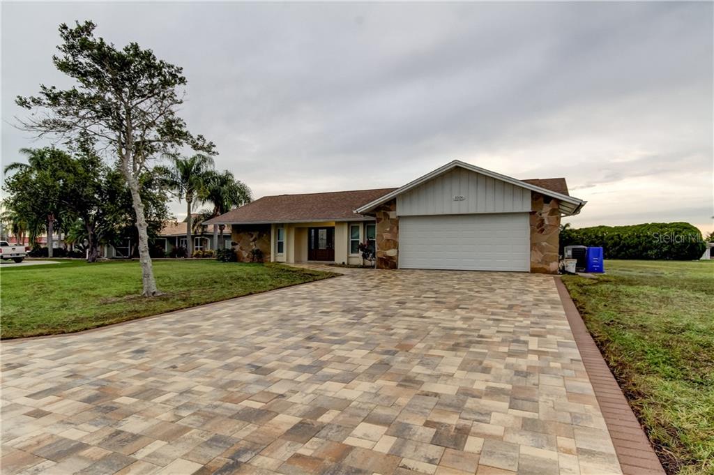 a front view of house with yard and green space
