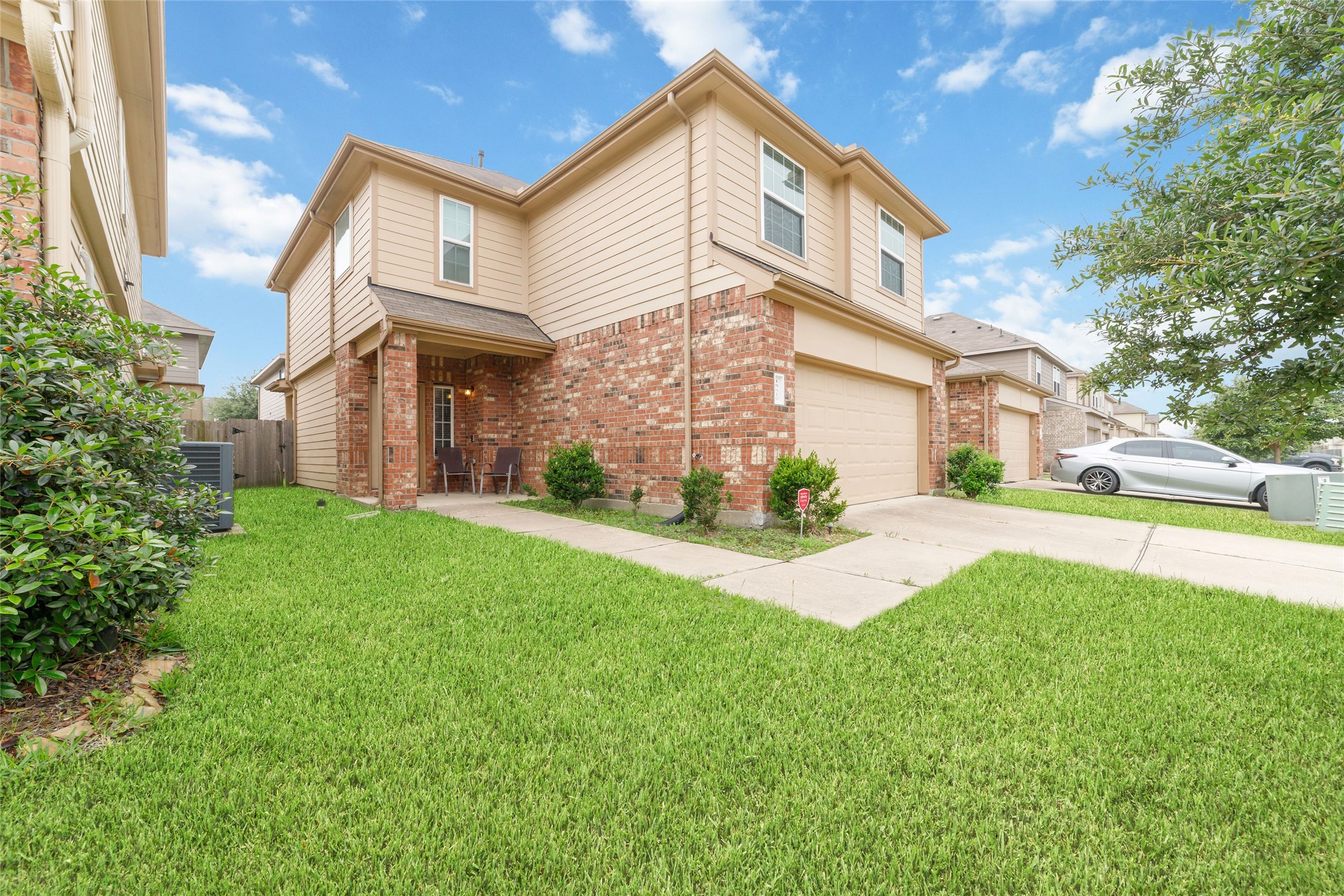 18619 Cooper Ravine Way Katy, TX 77449 - Photo 3 of 23 a view of a white house next to a yard with big trees