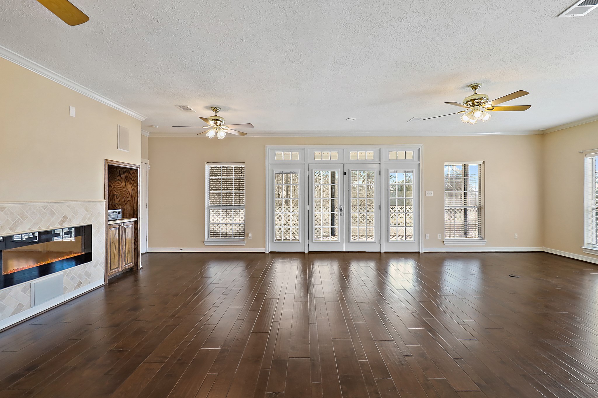 1306 Spring Branch Drive Baytown, TX 77523 - Photo 31 of 38 a view of an empty room with a kitchen and wooden floor