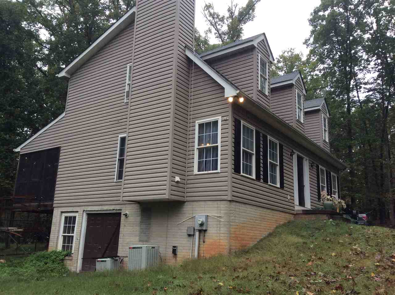 4003 Ruth Road Madison, VA 22727 - Photo 3 of 38 a front view of a house with a garden and trees
