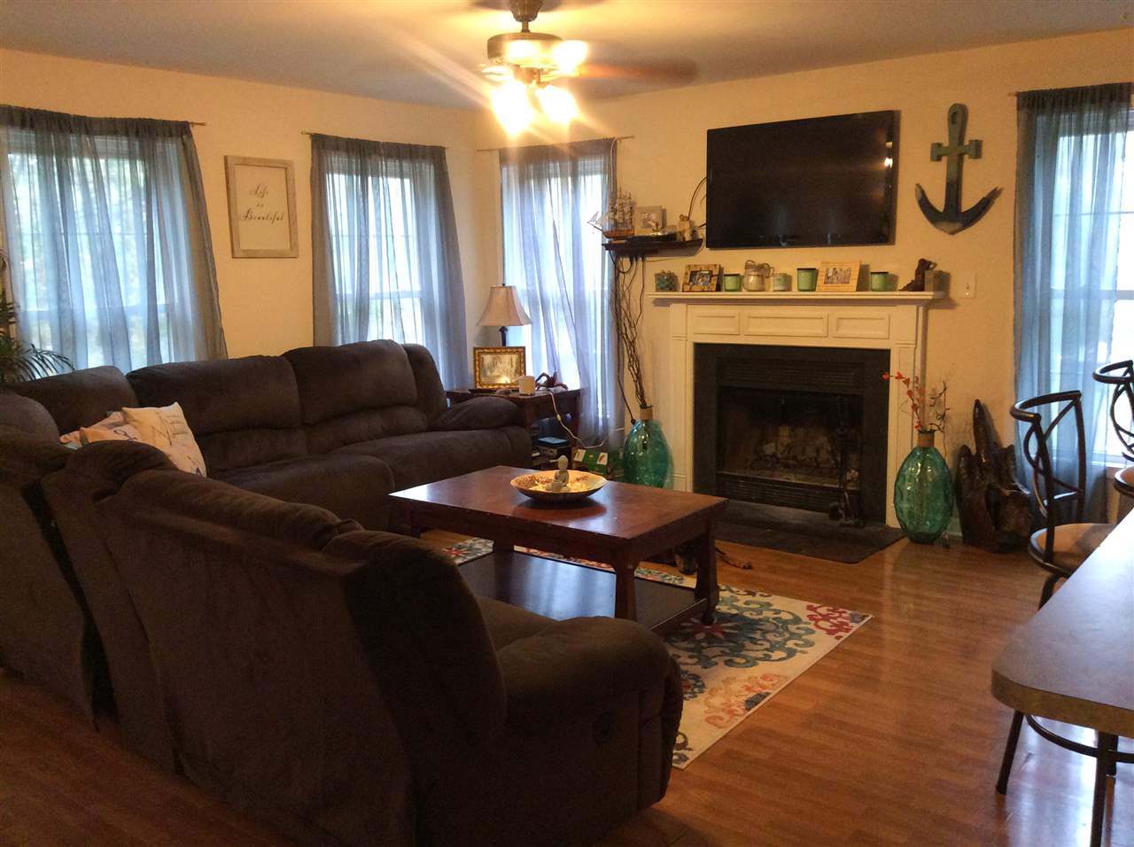 4003 Ruth Road Madison, VA 22727 - Photo 7 of 38 a living room with furniture a flat screen tv and a fireplace