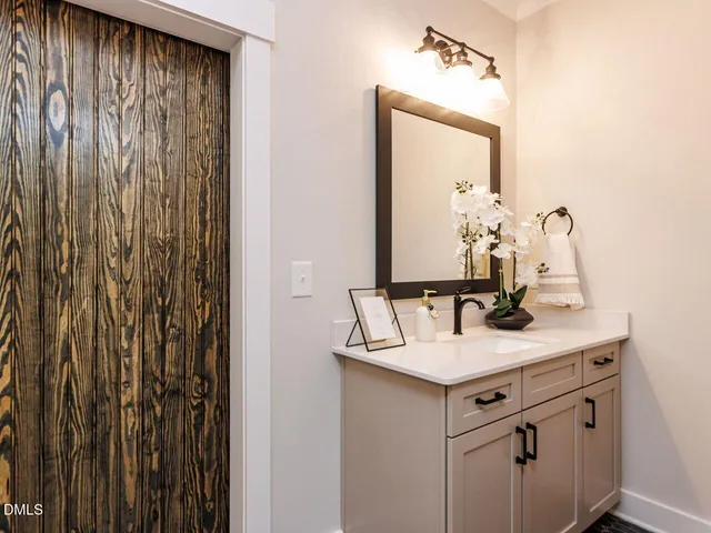 a bathroom with a sink vanity and a mirror