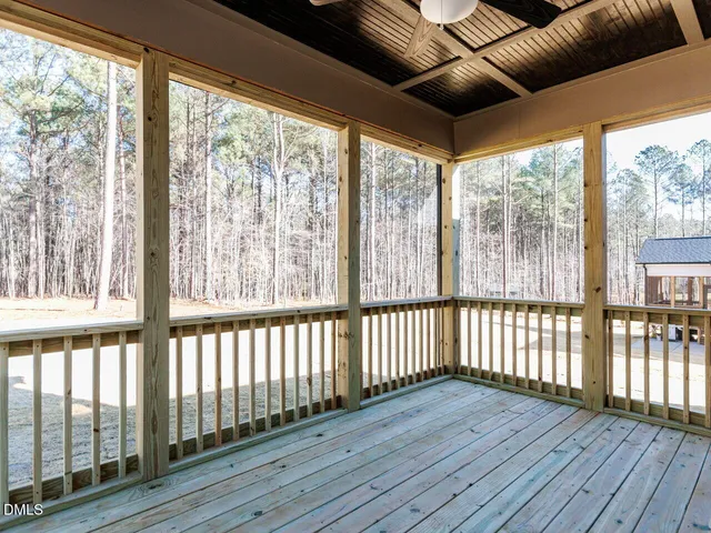 a view of a porch with wooden floor
