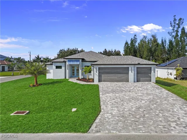 a front view of a house with a yard and garage