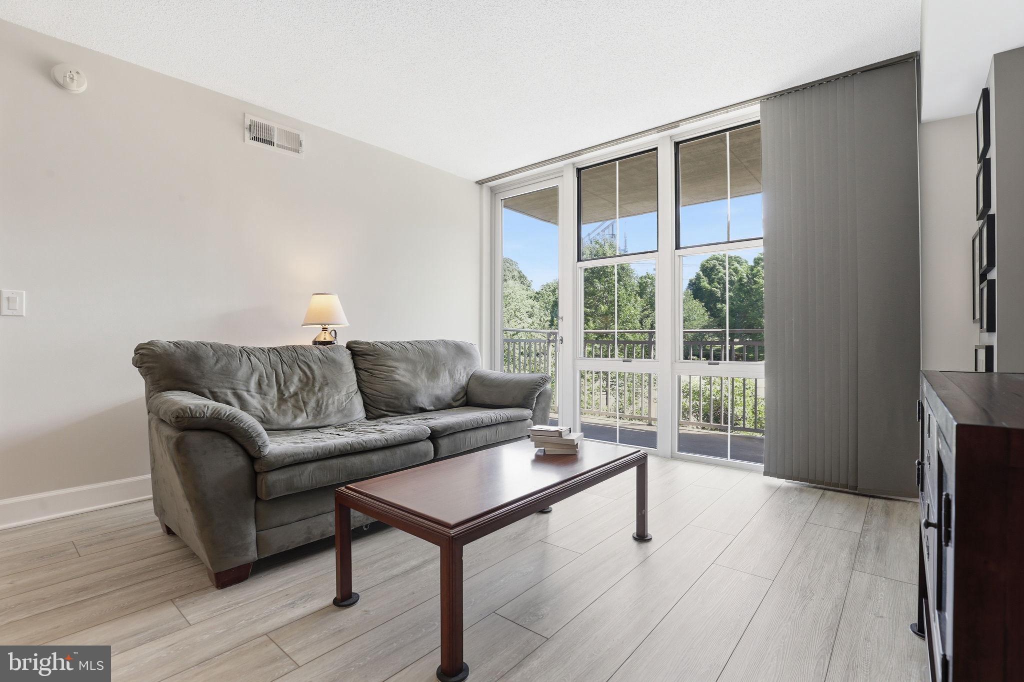 11800 Sunset Hills Road, Unit 218 Reston, VA 20190 - Photo 2 of 38 a living room with furniture and a gate
